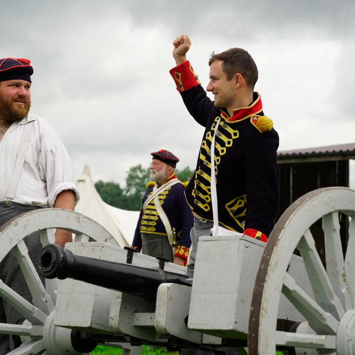 KGA members talking behind a cannon